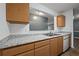 Well-lit kitchen featuring wood cabinetry, granite countertops, and modern appliances at 3303 Par Three Way, Lithonia, GA 30038