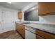 Well-lit kitchen features wood cabinets, laminate countertop and stainless steel sink at 3303 Par Three Way, Lithonia, GA 30038