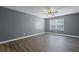 Bright, empty living room featuring wood floors, neutral paint, and a ceiling fan at 3303 Par Three Way, Lithonia, GA 30038