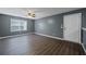 Bright, empty living room featuring wood floors, neutral paint, and a ceiling fan at 3303 Par Three Way, Lithonia, GA 30038
