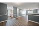 Open-concept living room, with sight lines to kitchen featuring wood floors and light-grey paint at 3303 Par Three Way, Lithonia, GA 30038