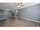 Open-concept living room featuring hard wood floors and light-grey paint at 3303 Par Three Way, Lithonia, GA 30038