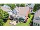 Aerial view showcases the home's backyard with a screen porch and patio, nestled amongst mature trees at 3812 Mine Creek Ln, Marietta, GA 30062