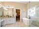Luxurious bathroom with a soaking tub, walk-in shower, and elegant vanity at 3812 Mine Creek Ln, Marietta, GA 30062