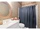 Cozy bathroom with a single vanity, shower, and decorative wallpaper at 3812 Mine Creek Ln, Marietta, GA 30062