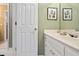 Bright bathroom with white vanity, decorative fixtures, and a view into the hallway at 3812 Mine Creek Ln, Marietta, GA 30062