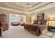 Spacious main bedroom with sitting area, tray ceilings, and a large bed at 3812 Mine Creek Ln, Marietta, GA 30062
