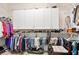 Organized walk-in closet with clothing racks, overhead cabinets and shelves for ample storage at 3812 Mine Creek Ln, Marietta, GA 30062