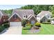 Landscaped front exterior of a brick home with well-maintained lawn and mature trees at 3812 Mine Creek Ln, Marietta, GA 30062