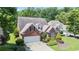 Brick home featuring a lush, green lawn and mature trees adding privacy and charm at 3812 Mine Creek Ln, Marietta, GA 30062