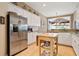 Well-lit kitchen with white cabinets, stainless steel appliances, and granite countertops at 3812 Mine Creek Ln, Marietta, GA 30062