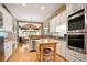 Eat-in kitchen with white cabinets, stainless steel appliances, and attached dining area at 3812 Mine Creek Ln, Marietta, GA 30062