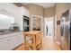 Bright kitchen featuring white cabinets, stainless steel appliances, and wooden floors at 3812 Mine Creek Ln, Marietta, GA 30062