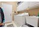 Bright laundry room with modern appliances, storage cabinets, and utility sink at 3812 Mine Creek Ln, Marietta, GA 30062