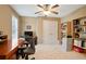Comfortable office space with a ceiling fan, large desk, and built-in bookshelves at 3812 Mine Creek Ln, Marietta, GA 30062