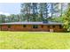 Brick house featuring an expansive backyard with mature trees, providing a private and peaceful atmosphere at 3219 W Manor Ln, Atlanta, GA 30311