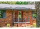 Close up of brick house with covered porch and gray trim at 3219 W Manor Ln, Atlanta, GA 30311