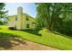 Spacious backyard with lush green lawn and mature trees, perfect for outdoor activities at 3554 Cherry Bloom Way, Decatur, GA 30034