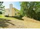 Expansive backyard with mature trees and lush greenery offers ample space for outdoor activities at 3554 Cherry Bloom Way, Decatur, GA 30034