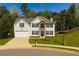Charming two-story home featuring a well-manicured lawn, two-car garage, and a stone-accented entryway at 3554 Cherry Bloom Way, Decatur, GA 30034