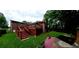 A backyard featuring a stained, elevated wood deck and a well-maintained lawn at 3769 Amber Nw Rd, Atlanta, GA 30331