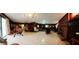 Expansive basement with a brick fireplace, wood paneling, and sliding glass doors at 3769 Amber Nw Rd, Atlanta, GA 30331