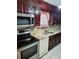 Kitchen featuring stainless steel appliances, granite countertops, and dark wooden cabinets at 3769 Amber Nw Rd, Atlanta, GA 30331