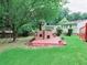 An outdoor fireplace and patio area with a lush lawn in the backyard at 3769 Amber Nw Rd, Atlanta, GA 30331