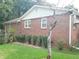 Brick home's side exterior featuring mature landscaping and maintained lawn at 3769 Amber Nw Rd, Atlanta, GA 30331