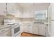Functional kitchen with white cabinets, essential appliances, and ample counter space for meal prep at 4954 Browns Mill Rd, Lithonia, GA 30038