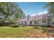 Expansive backyard with lush greenery, mature trees and covered patio space at 600 Cowan Rd, Covington, GA 30016