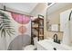 Modern bathroom with stylish shower curtain, shelving unit, and sleek black fixtures at 600 Cowan Rd, Covington, GA 30016