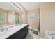 Bathroom featuring a double vanity, large mirror, and a shower-tub combo at 600 Cowan Rd, Covington, GA 30016