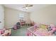 Cozy bedroom decorated with toys, a dollhouse, and a pink crib, creating a playful atmosphere at 600 Cowan Rd, Covington, GA 30016