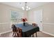 Charming dining area showcasing natural light, wood floors, and seating for six around a table at 600 Cowan Rd, Covington, GA 30016