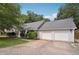 Well-maintained single-story home with a two-car garage and an American flag displayed on the porch at 600 Cowan Rd, Covington, GA 30016