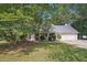 Inviting single-story home featuring an attached two-car garage and a well-manicured front lawn at 600 Cowan Rd, Covington, GA 30016