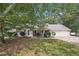 Inviting single-story home with a well-manicured lawn and mature shade trees adding curb appeal at 600 Cowan Rd, Covington, GA 30016