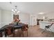 Bright kitchen with white cabinets, appliances, and a view to the adjacent dining room with table and chairs at 600 Cowan Rd, Covington, GA 30016
