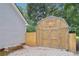 Backyard storage shed and partial home view with privacy fence at 600 Cowan Rd, Covington, GA 30016