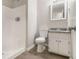 Clean bathroom featuring a shower, toilet, vanity with granite counters and wood-look floors at 100 Spicewood Ct, South Fulton, GA 30349