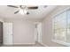 Bedroom featuring carpet, ceiling fan, window, and view into ensuite at 100 Spicewood Ct, South Fulton, GA 30349