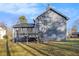 Back exterior of house with wooden deck and large yard, perfect for outdoor living and entertaining at 100 Spicewood Ct, South Fulton, GA 30349