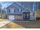 Charming two-story home featuring a stone facade and blue siding at 100 Spicewood Ct, South Fulton, GA 30349