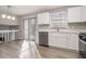Bright eat-in kitchen with stainless appliances, white cabinets, and a sliding glass door at 100 Spicewood Ct, South Fulton, GA 30349