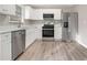 Modern kitchen featuring stainless steel appliances, white cabinets, and light countertops at 100 Spicewood Ct, South Fulton, GA 30349