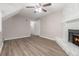 Cozy living room features wood floors and a stone fireplace at 100 Spicewood Ct, South Fulton, GA 30349