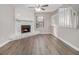 Cozy living room features wood floors and a stone fireplace at 100 Spicewood Ct, South Fulton, GA 30349