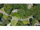 Aerial view of a neighborhood with lush, mature landscaping surrounding the homes at 1565 Kings Xing, Smoke Rise, GA 30087
