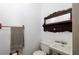 Cozy powder room with vintage mirror and pedestal sink provides functionality at 1565 Kings Xing, Smoke Rise, GA 30087